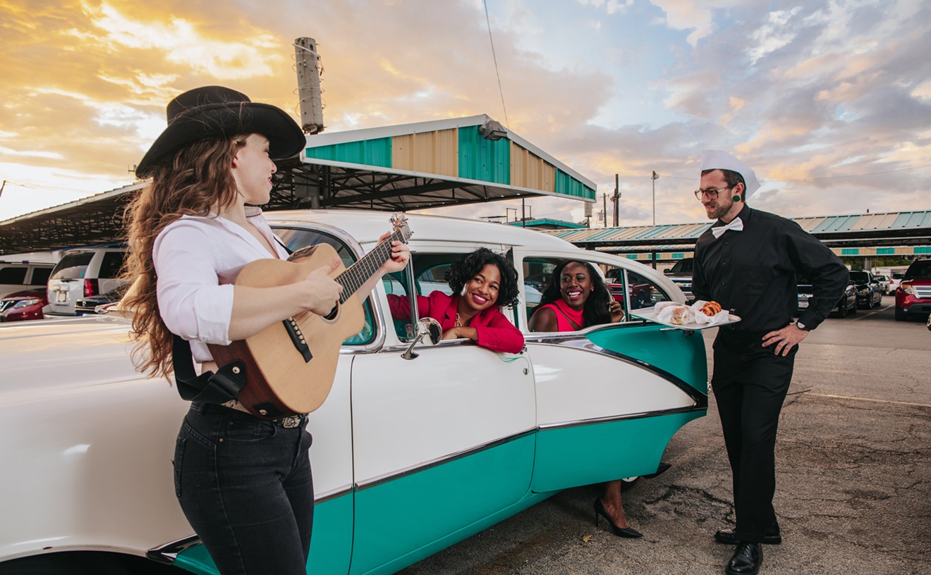 Entertainment for a COVID world. Taylor Shead and Olivia Taylor listen to Ashley Whitby play guitar while being served food by Casey Reid at Keller's drive in. Vintage car owned by Lindel.