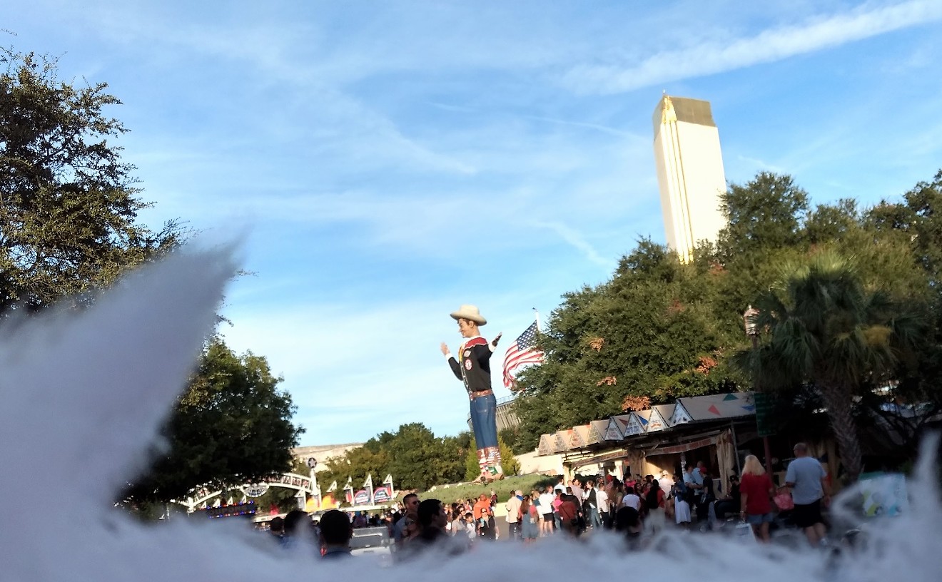 Big Tex, as seen over a half-eaten cone of cotton candy at the State Fair of Texas
