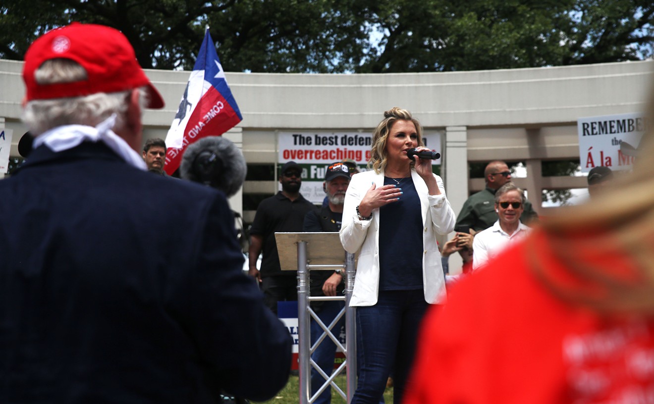 Shelley Luther, owner of Salon a la Mode, speaks at an Open Texas rally in Dealey Plaza.
