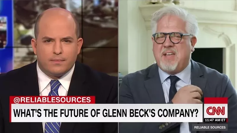 TheBlaze host and founder Glenn Beck (right) begins to take off his lapel mic in the middle of an interview with CNN's Brian Stelter during the CNN reporter's Sunday morning media show, Reliable Sources.