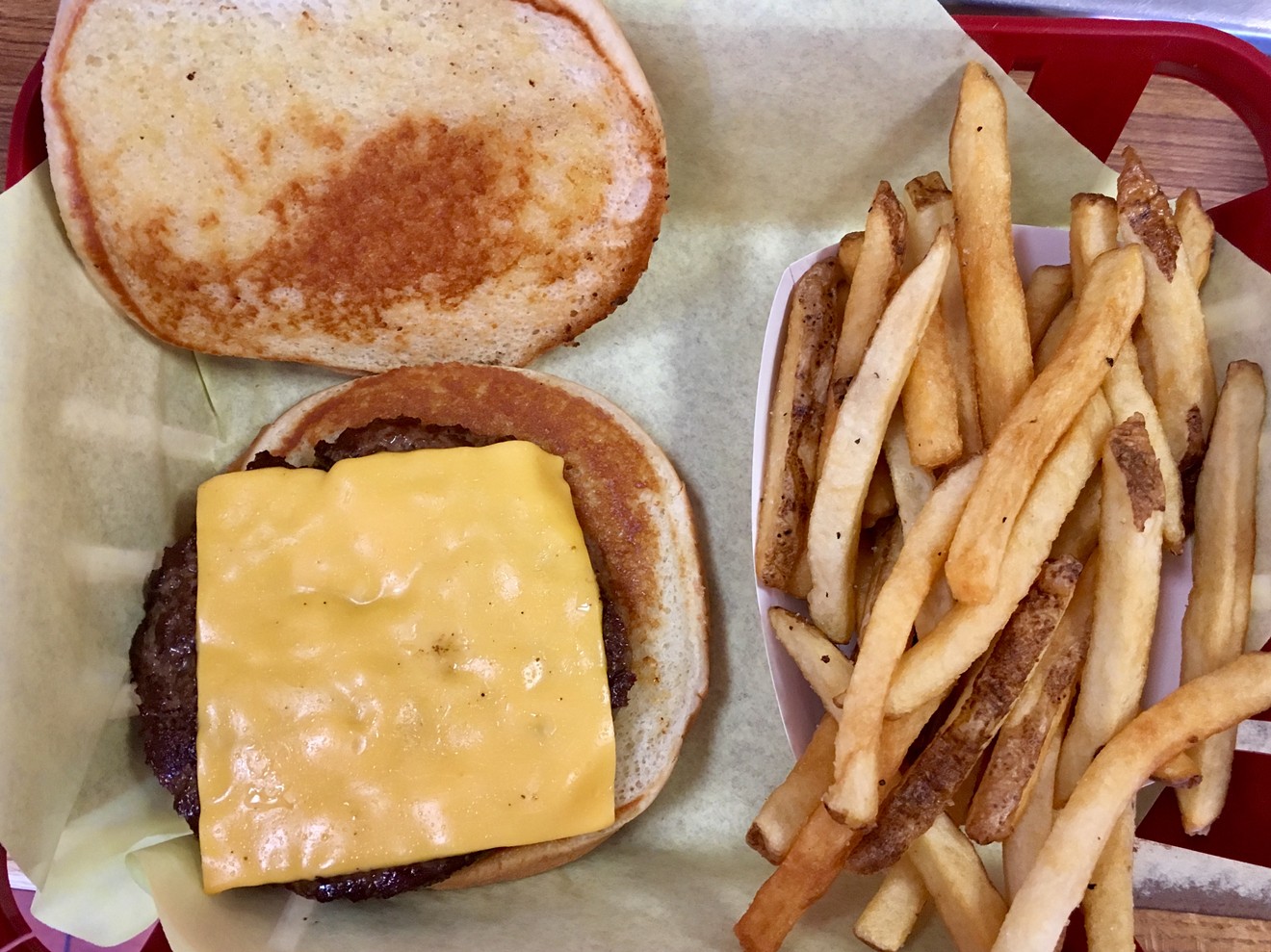A cheeseburger with fries is $6.55. Toppings are at the toppings bar.