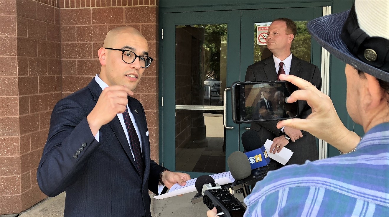 Dallas school trustee Miguel Solis, left, at a press conference Tuesday at Cesar Chavez Learning Center. John Turner, Democratic candidate for Texas House District 114, is in the background.