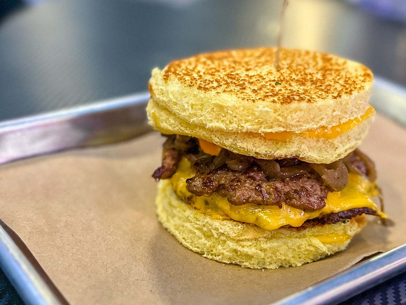 The Meltdown, a grilled cheese sandwich/hamburger combo, is just one of the burgers you can enjoy while sipping your boozy milkshake at Nitro Burger.