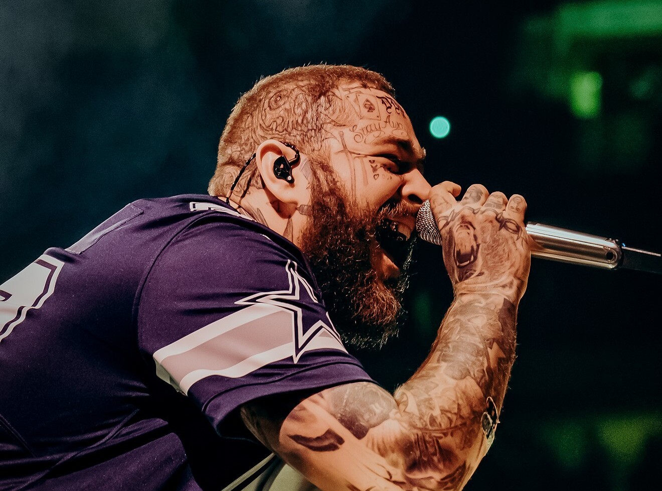 Post Malone performing at AT&T Stadium. One of his songs, a lawsuit claims, is not exactly his own.
