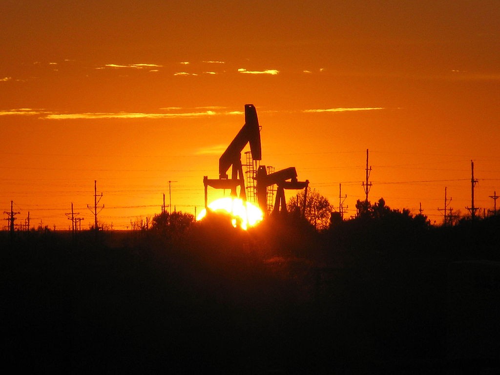The sun sets behind a pump jack near Midland.