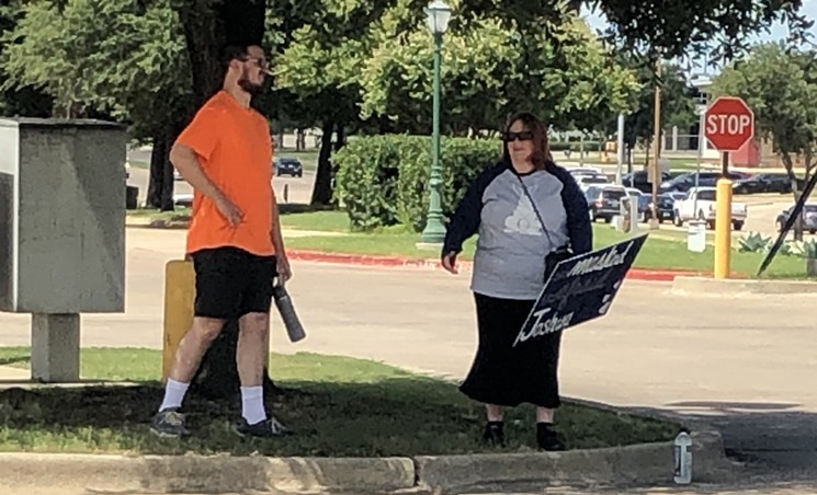 Two anti-mask ordinance protesters showed up in the parking lot of a Kroger store in Irving to a protest against mask laws that was organized by Sam Walker, left, and attended by Shelley Allen. Two more protesters showed up later along with some Irving police officers.