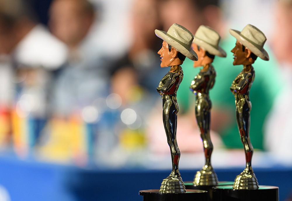 It takes a lot of work for a State Fair vendor to win one of these babies. (Is it just us, or is Big Tex looking a little ... not entirely cis here? Maybe not, but we're telling all the conservatives we know that he is, just to annoy them.)