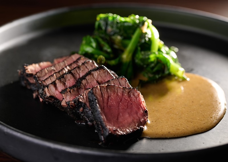 Wagyu New York strip is served deep ruby red and wrapped in a perfect char.