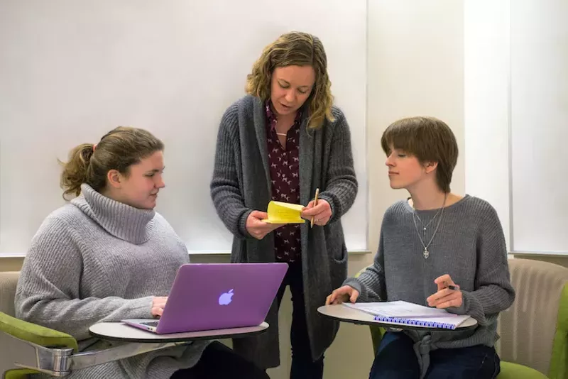 Image: A criminology doctoral student works with a biology and computer science sophomore on a comprehensive database of school shooting incidents starting in 1990.
