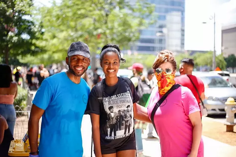 Image: Valery Jean-Bart (left) has been attending protests recently, frequently shouting, "Are you registered to vote?"