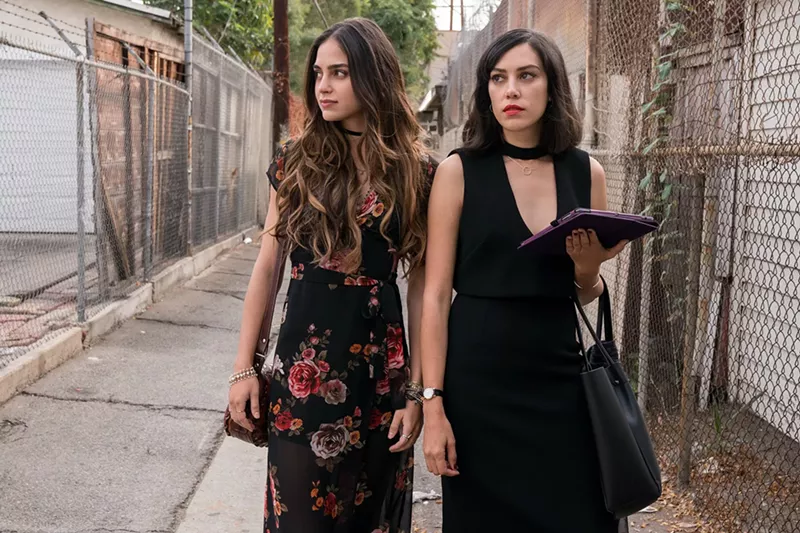 Image: Melissa Barrera (left) plays Lyn and Mishel Prada is Emma, two sisters in a Latinx family returning to their gentrified neighborhood in Los Angeles after the death of their mother in the Starz drama Vida.