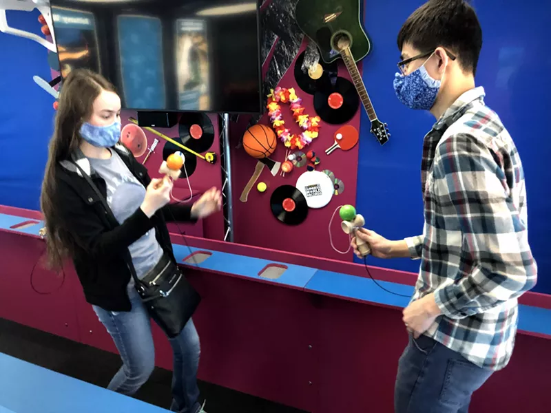 Image: Lara and Jay Park of Waco attempt to master the Japanese juggling toy kendama in an interactive video exhibition explaining the physics and strategies of mastering the toy, hosted by U.S. kendama world record holder Andrew Jin.