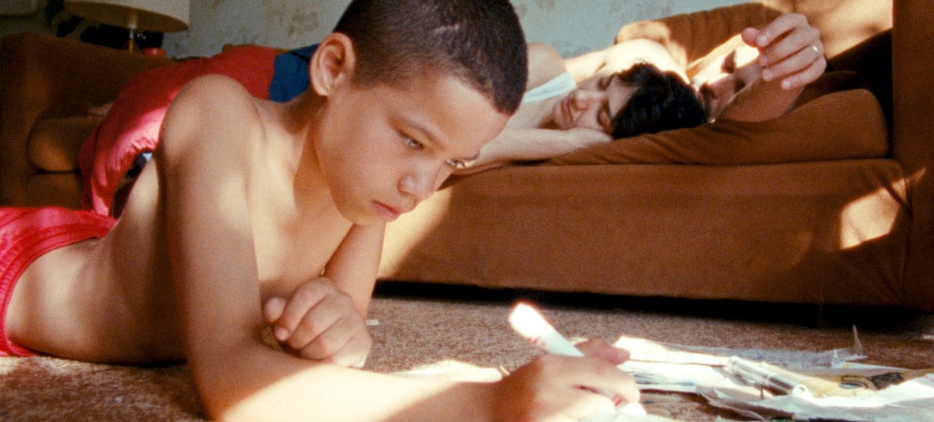 In We the Animals, Evan Rosado (left) plays Jonah, the youngest of three vigorously rambunctious, perennially shirtless brothers raised in upstate New York by parents (Sheila Vand, Raul Castillo) who are volatile and overwhelmed.