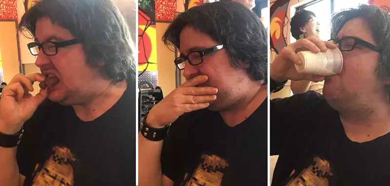 Image: Danny Gallagher takes a bite of the reaper, the hottest level at Dave's Hot Chicken.