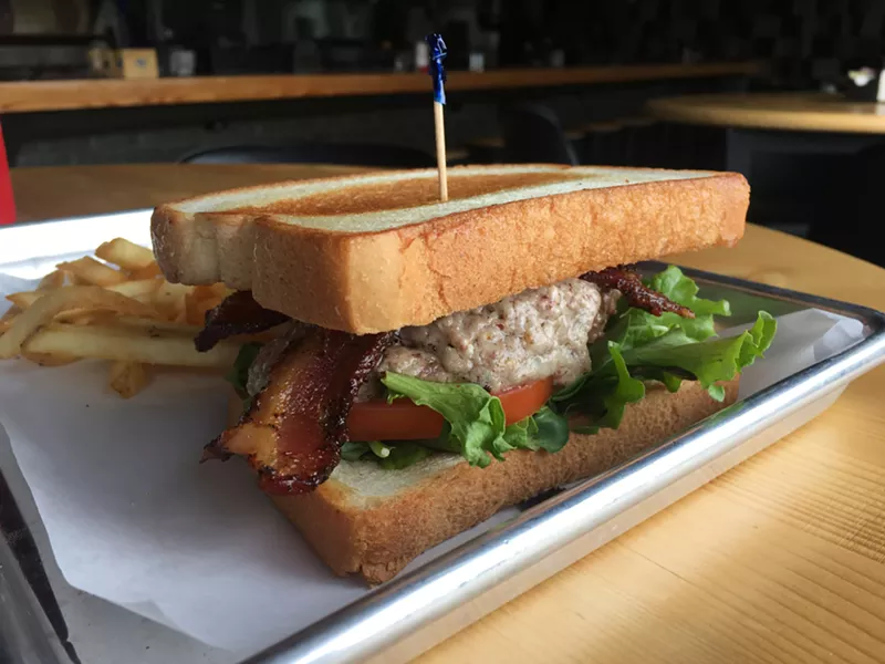 Image: The "Pecan Bleu Cheese Burger," with chunky sauce of blue cheese and pecans, at Haymaker on Greenville. It's flame-grilled and served on Texas Toast.