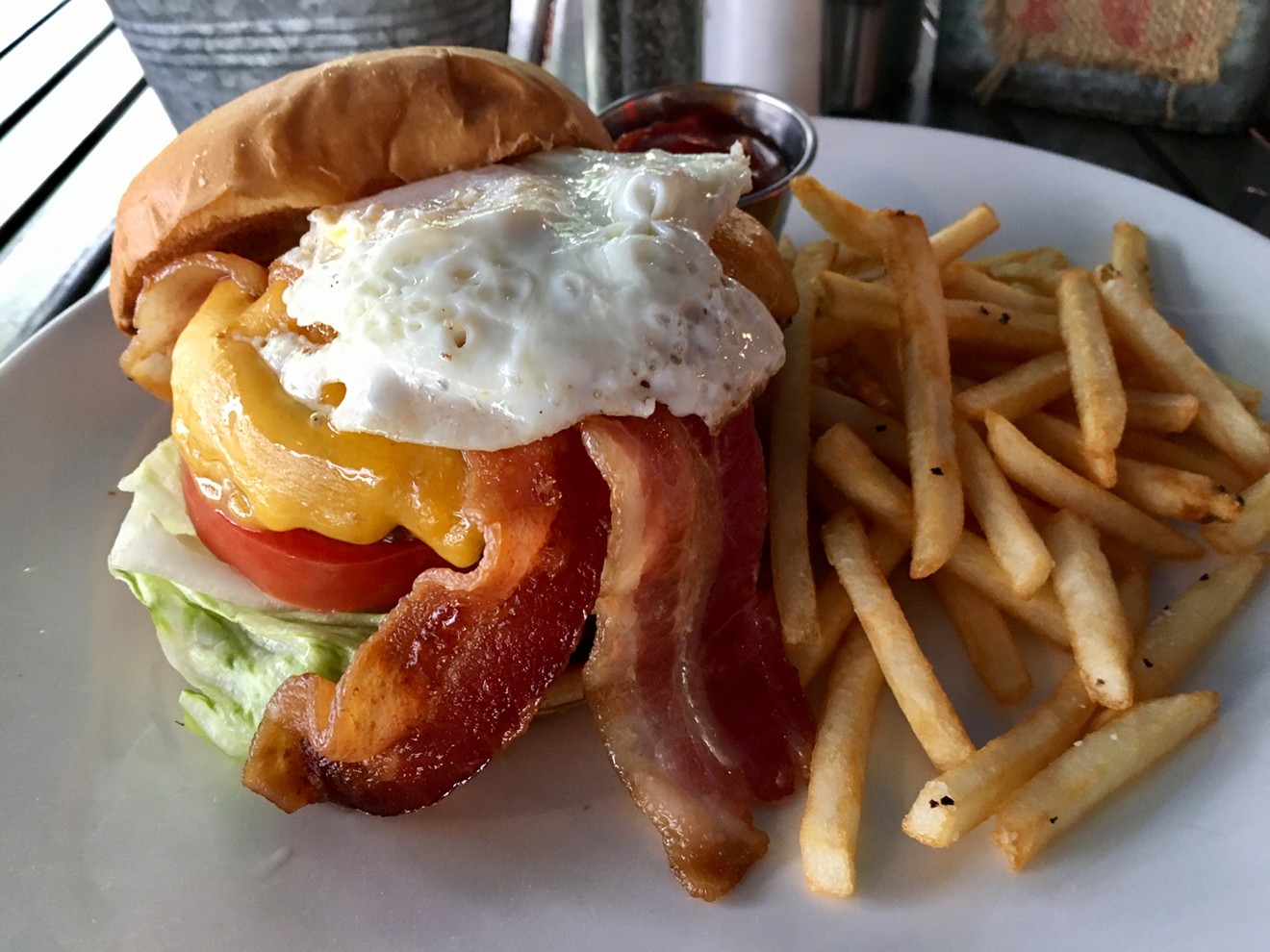 The cheddar-blanketed Egg Burger at Fat Chicken is $12.