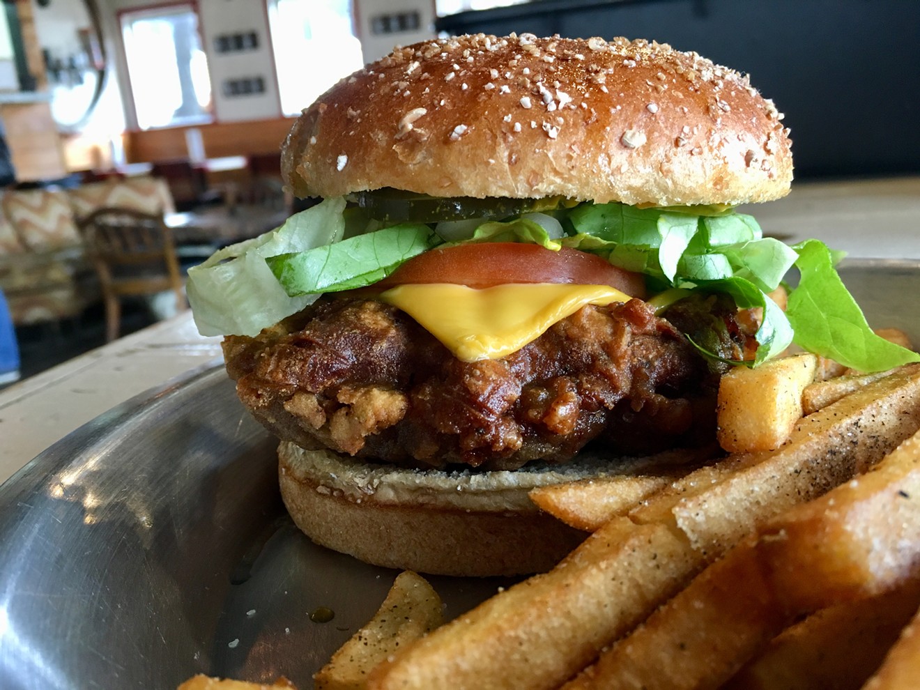 The chicken-fried burger at Chicken Scratch is $12 with French fries tossed with a sweet, spicy dust.
