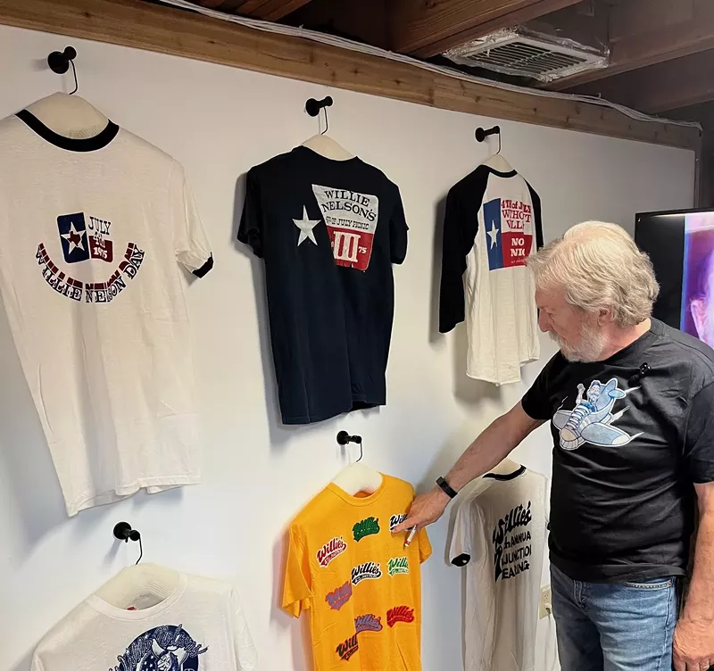 Image: Steve Brooks, a Willie Nelson expert, shows his own images, forever immortalized on T-shirts and other merch.