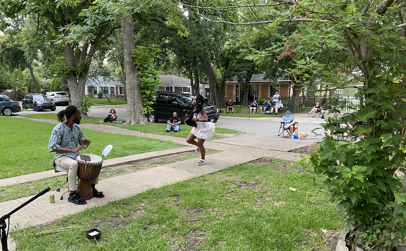 Neighbors watch musicians performing in Matthew Kurzman's front yard.
