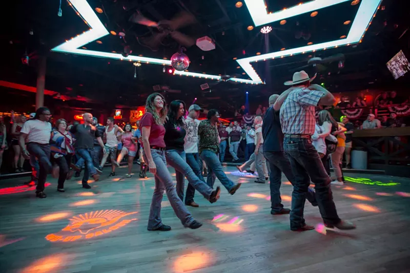 Image: A group line dancing at The Round-Up Saloon and Dance Hall