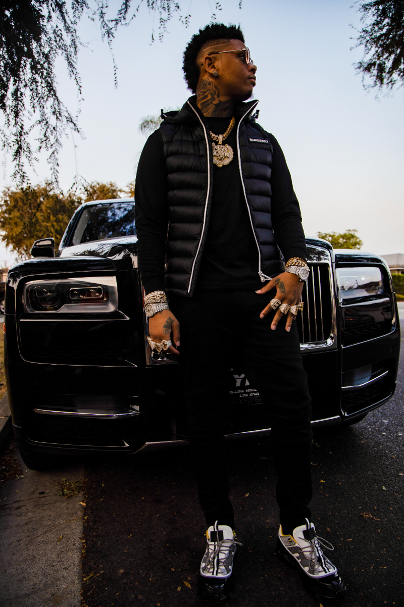Image: Man posing in front of a car
