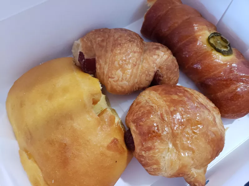 Image: A boudin kolache along with sausage and bacon croissant rolls from Cajun Donuts II in Garland.