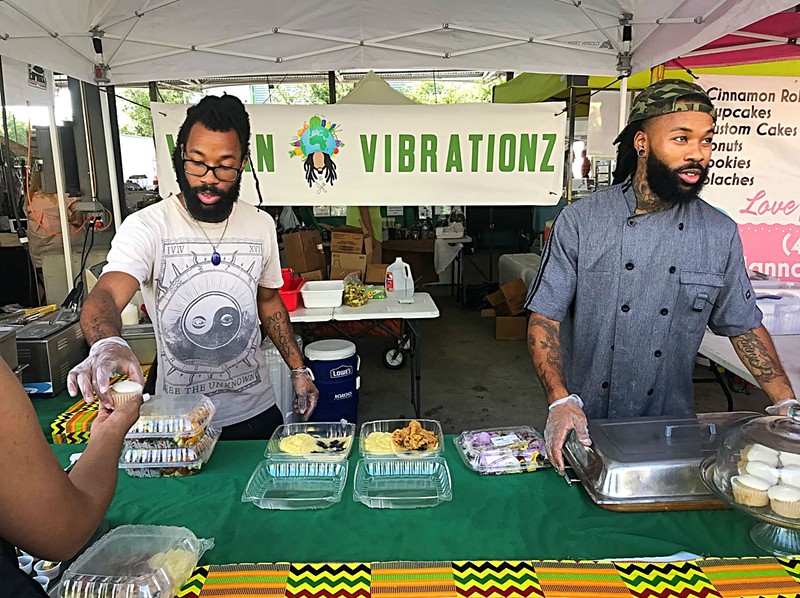 Joshua Cole (left) and Jovan Cole work the Vegan Vibrationz food stand at Dallas Farmers Market.