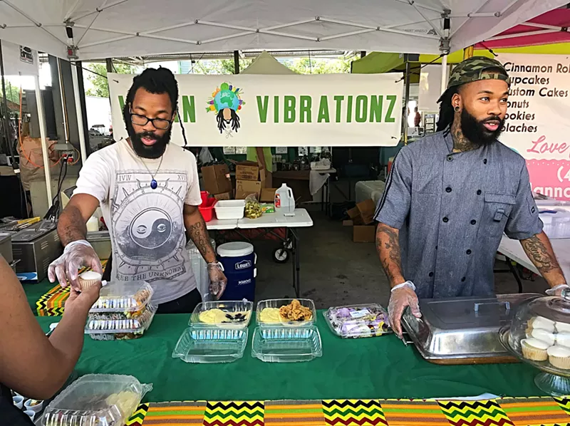 Image: Joshua Cole (left) and Jovan Cole work the Vegan Vibrationz food stand at Dallas Farmers Market.