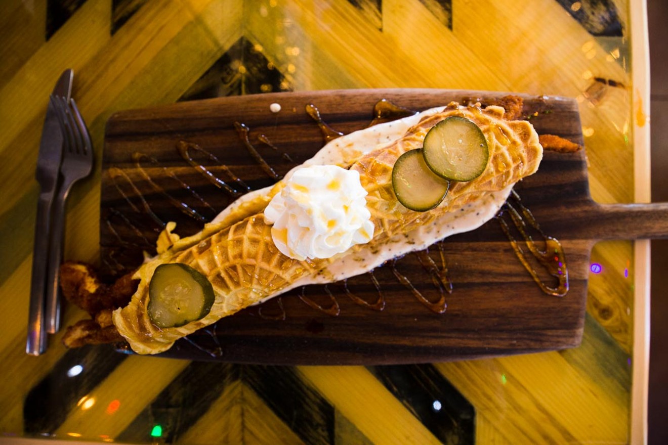 Really, it's a foot-long chicken and waffle cannoli. Normal-sized fork and knife for scale.